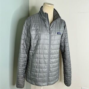 Women’s size large Patagonia puffer jacket.  The color is silver or gray.